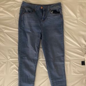 Blue jeans, with detailed back pockets.